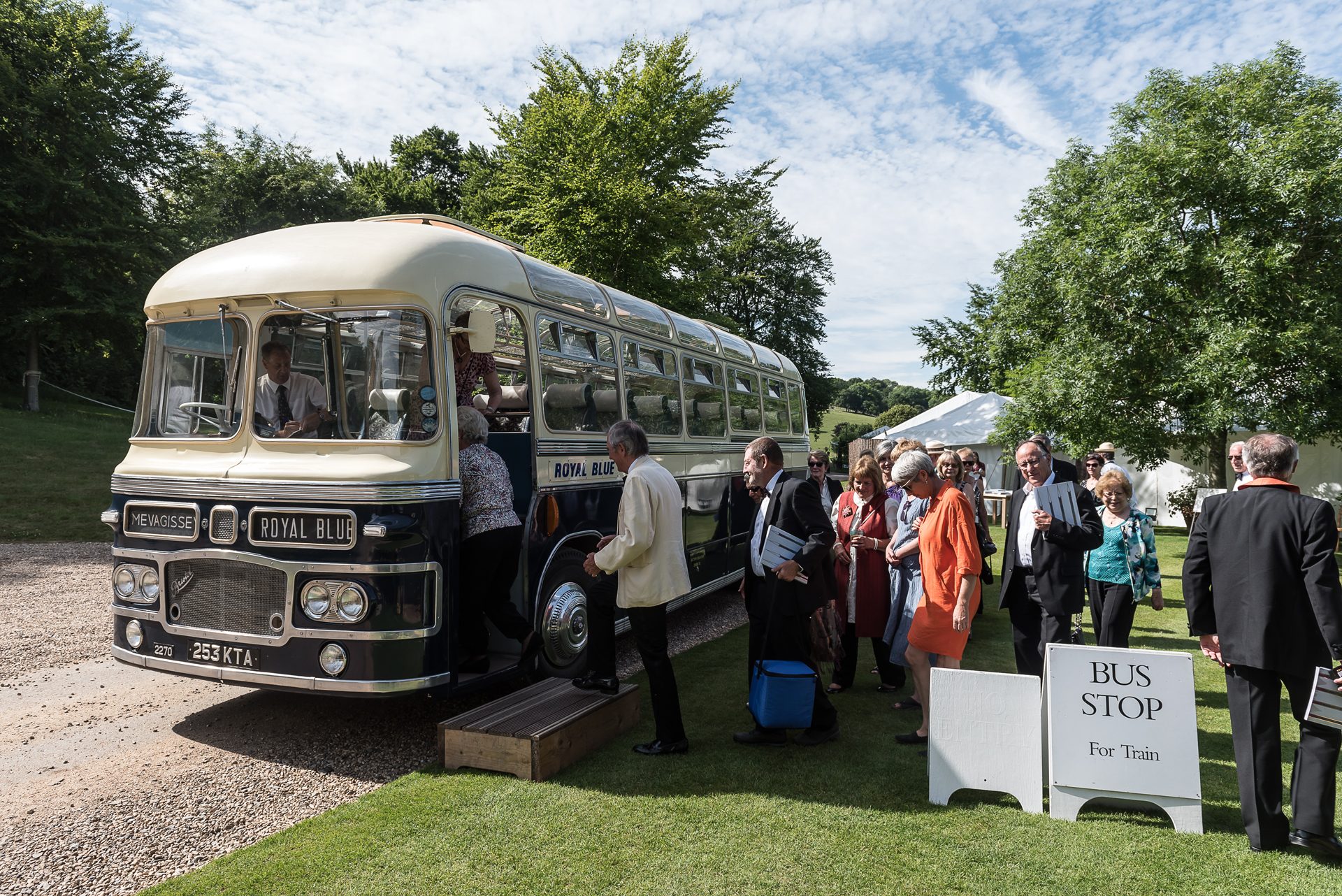 Audience members boarding a vintage bus