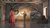 Gifts-in-Wills Stood in the centre at the back of the stage, a figure dressed in a silver, military-style suit holds a silver rose in their right hand. In front of them and to the left, another figure in a long, pink dress stands with their back towards us, looking towards the figure in silver, who is highlighted against a warm light behind them. An image from Garsington Opera's 2021 production of Der Rosenkavalier by Strauss.